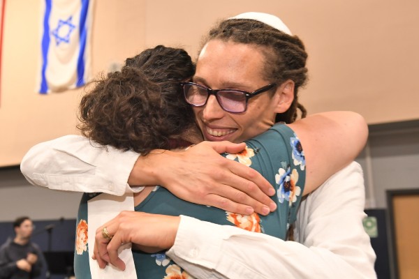 JEA Stein hugging colleague